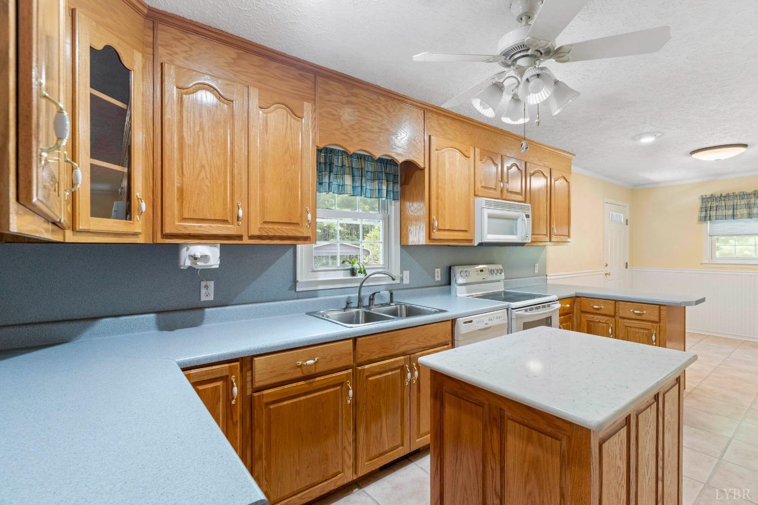 4681 Roark Mill Road Hurt, VA 24563 - Photo 9 of 76 a kitchen with stainless steel appliances granite countertop a sink a stove cabinets counter space and a window