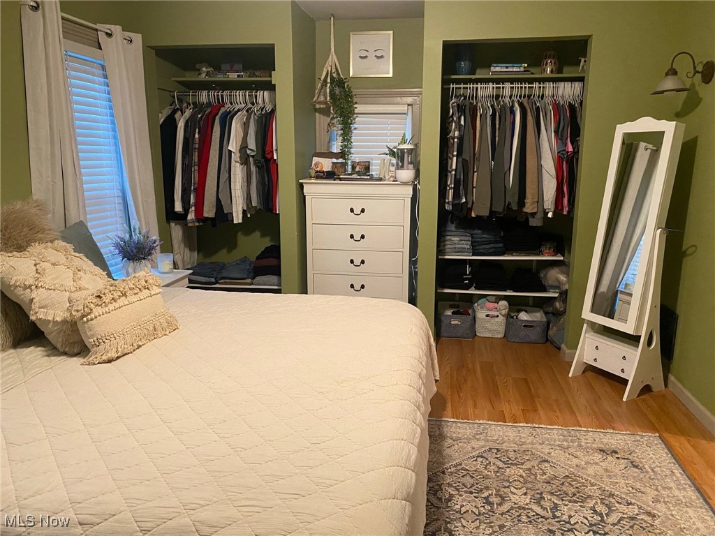 408 Broad State Road Conneaut, OH 44030 - Photo 21 of 39 Bedroom featuring light wood-type flooring and two closets