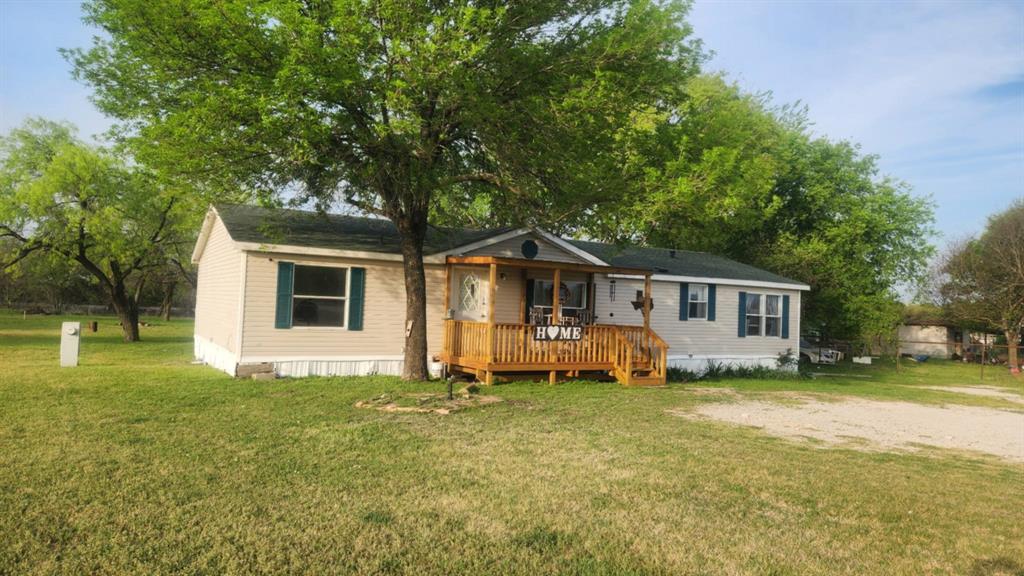 7241 South Interstate 45 Service Road Alma, TX 75119 - Photo 2 of 11 Manufactured / mobile home featuring a deck and a front yard