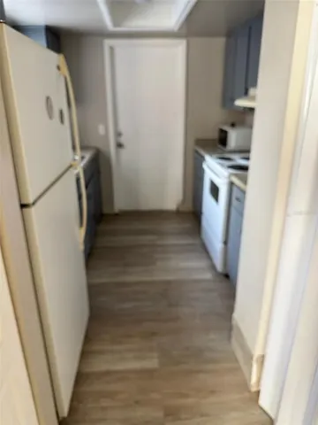 a view of a room with wooden floor