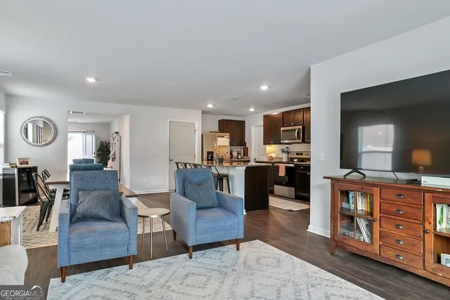 a living room with furniture and wooden floor