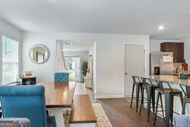 a kitchen with stainless steel appliances granite countertop a sink stove microwave refrigerator and cabinets