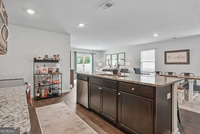 a kitchen with granite countertop a stove and a sink