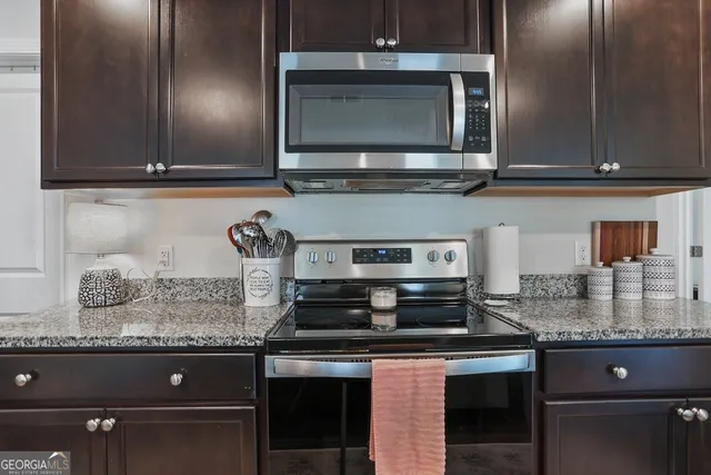 a kitchen with stainless steel appliances granite countertop a refrigerator and a sink