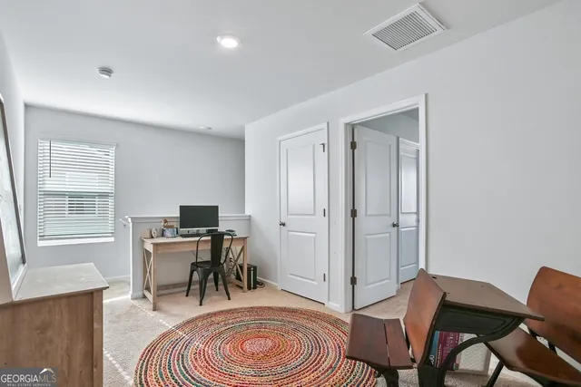 a room with a baby bed mirror and a dresser