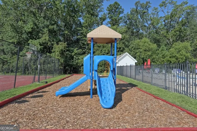 a front view of a house with a yard table and chairs