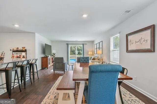 a view of a dining room with furniture and wooden floor