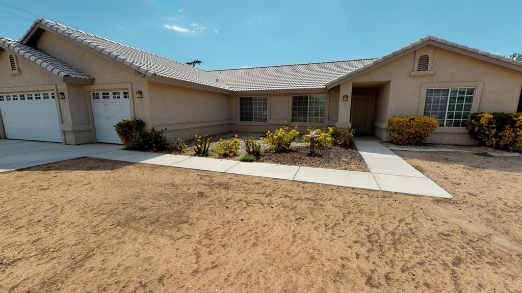13912 Crow Road Apple Valley, CA 92307 - Photo 1 of 1 a front view of a house with a yard