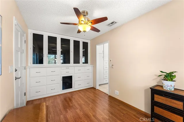 a living room with furniture a flat screen tv and wooden floor