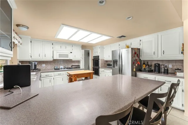 a kitchen with granite countertop a stove sink and cabinets