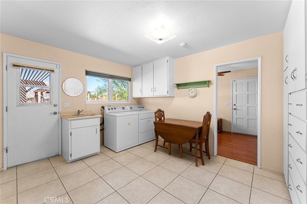 13346 Rimview Court Yucaipa, CA 92399 - Photo 23 of 60 Laundry room, built-in cabinets and 1/2 bath