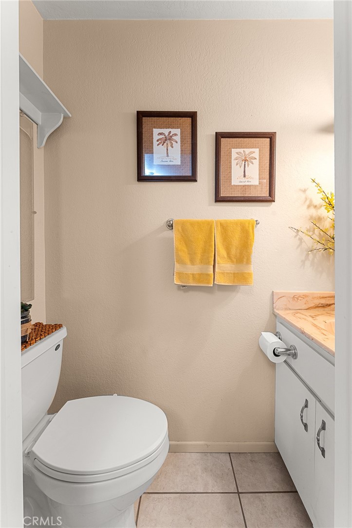 13346 Rimview Court Yucaipa, CA 92399 - Photo 25 of 60 a bathroom with a toilet sink and mirror