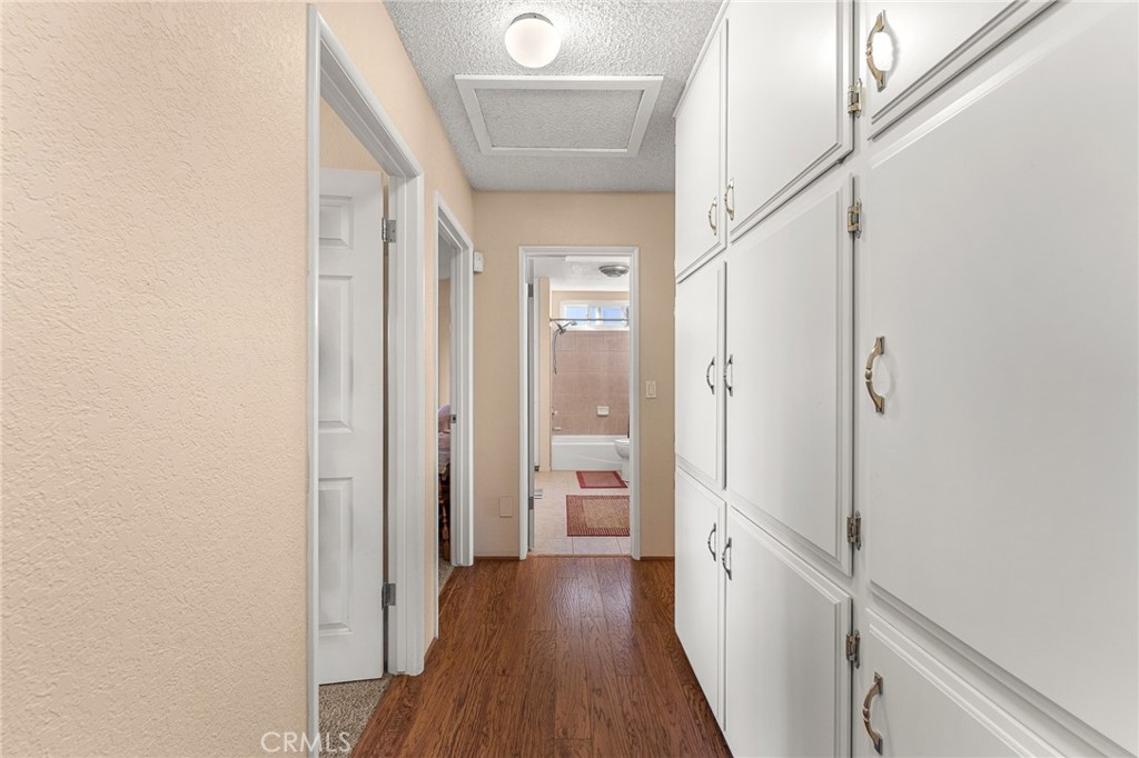 13346 Rimview Court Yucaipa, CA 92399 - Photo 28 of 60 a view of a hallway with wooden floor and staircase