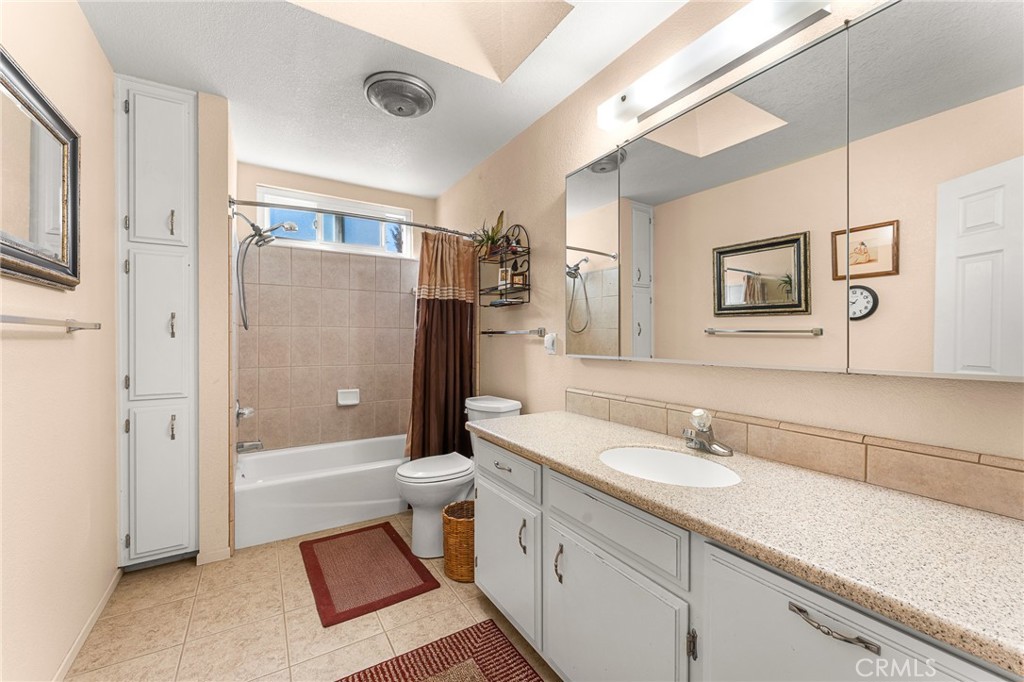 13346 Rimview Court Yucaipa, CA 92399 - Photo 31 of 60 a bathroom with a sink a toilet and shower