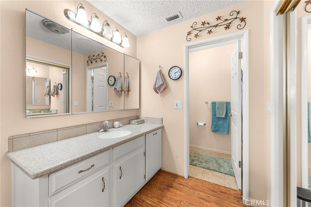 13346 Rimview Court Yucaipa, CA 92399 - Photo 35 of 60 a bathroom with a sink vanity and a mirror