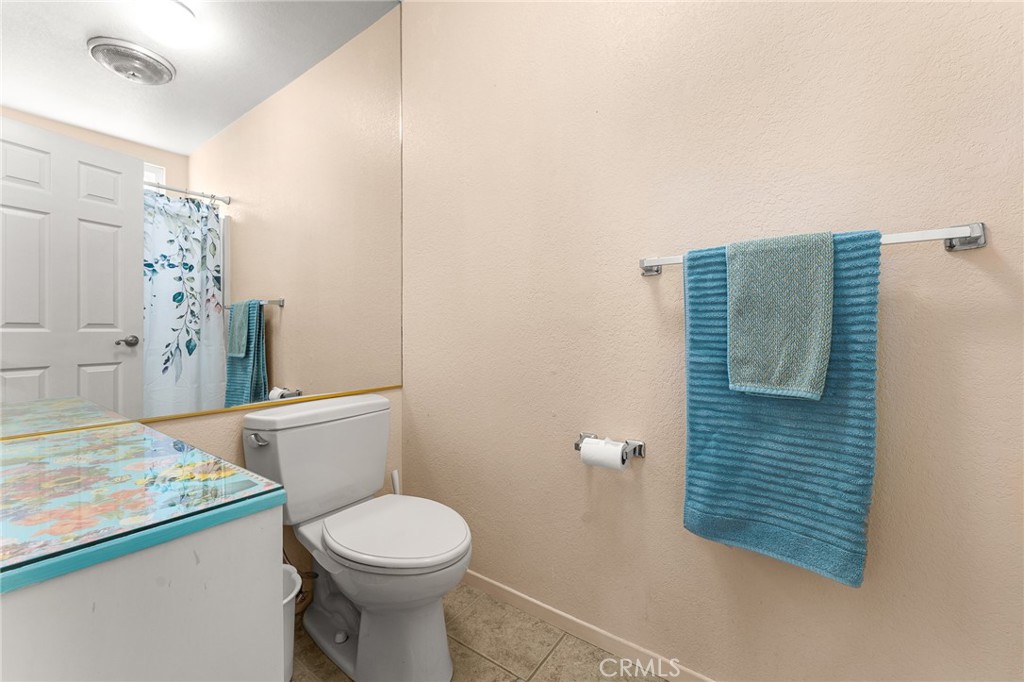 13346 Rimview Court Yucaipa, CA 92399 - Photo 36 of 60 a bathroom with a toilet and a shower