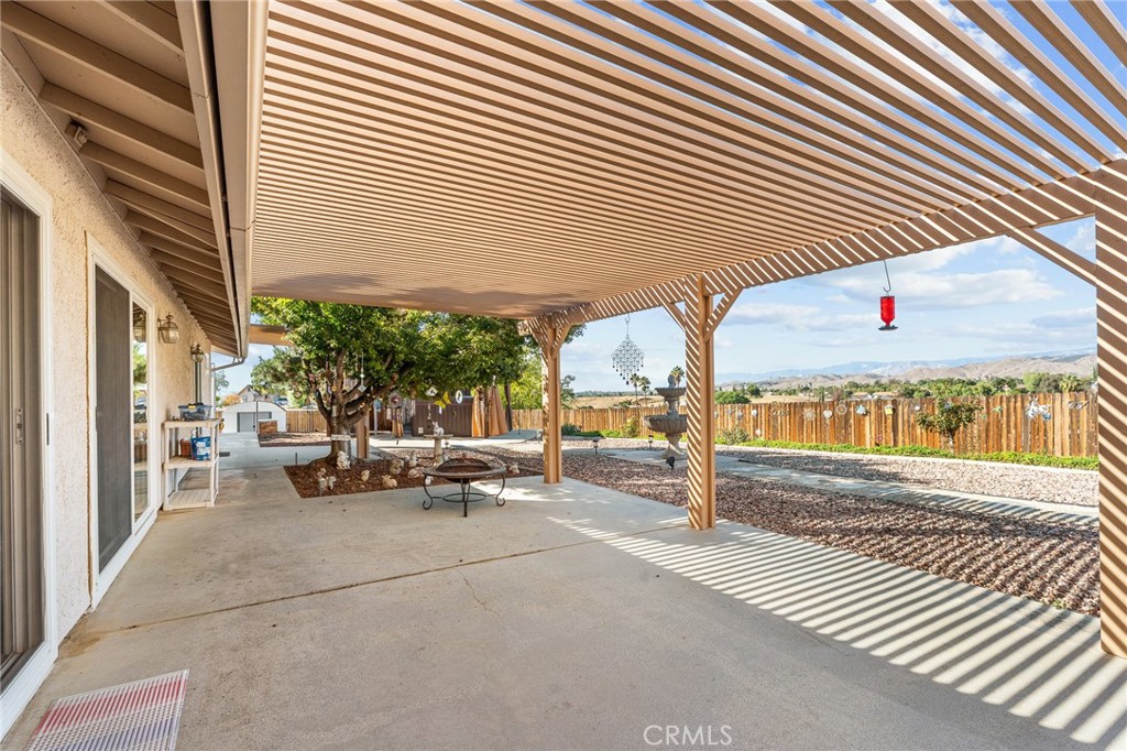 13346 Rimview Court Yucaipa, CA 92399 - Photo 39 of 60 a view of a patio with table and chairs and wooden fence