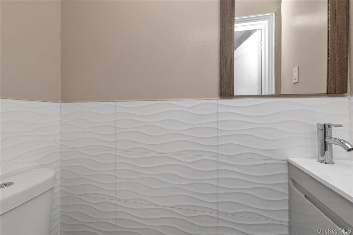 301 Merrifield Avenue Oceanside, NY 11572 - Photo 11 of 16 a bathroom with a sink and vanity