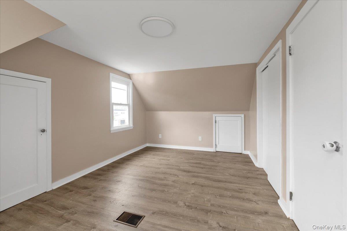 301 Merrifield Avenue Oceanside, NY 11572 - Photo 14 of 16 a view of an empty room with wooden floor and a window