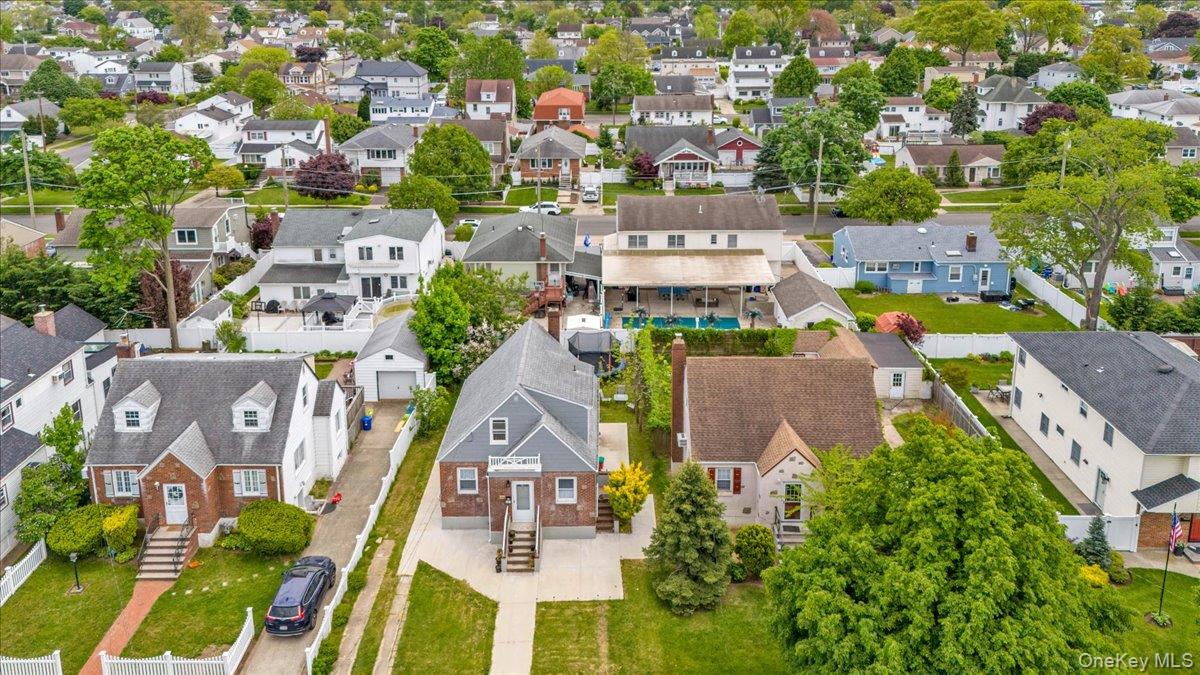 301 Merrifield Avenue Oceanside, NY 11572 - Photo 3 of 16 an aerial view of residential houses with outdoor space