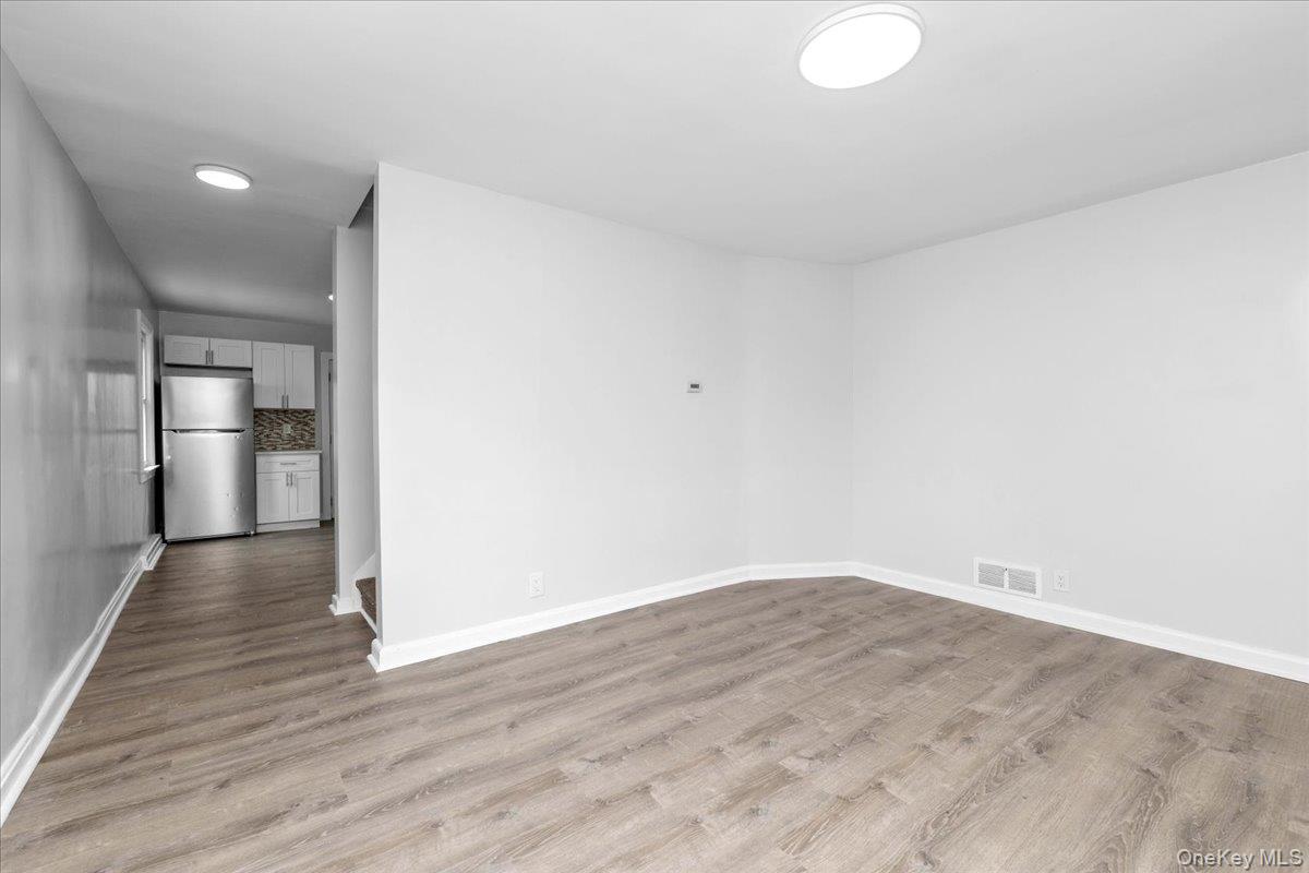 301 Merrifield Avenue Oceanside, NY 11572 - Photo 7 of 16 a view of empty room with wooden floor
