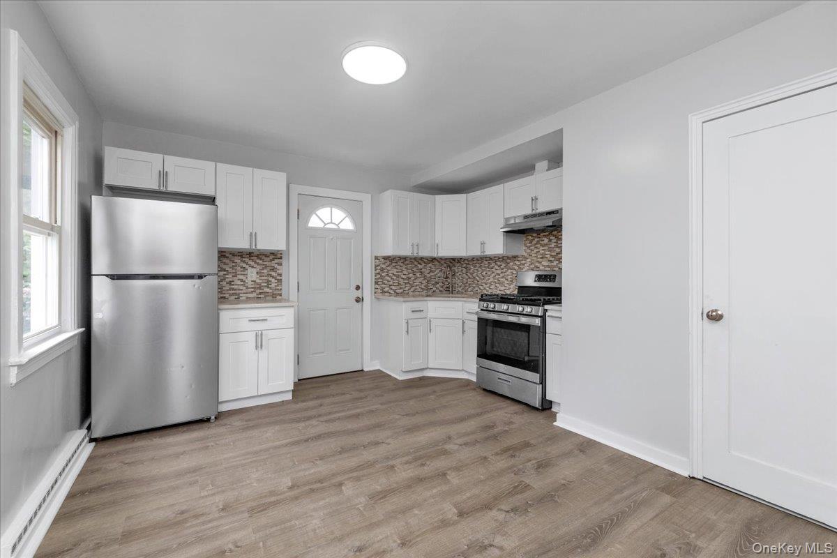301 Merrifield Avenue Oceanside, NY 11572 - Photo 9 of 16 a kitchen with stainless steel appliances a refrigerator sink and cabinets