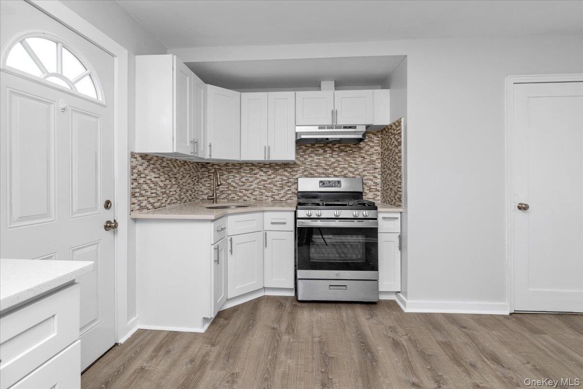 301 Merrifield Avenue Oceanside, NY 11572 - Photo 10 of 16 a kitchen with a sink cabinets and stainless steel appliances