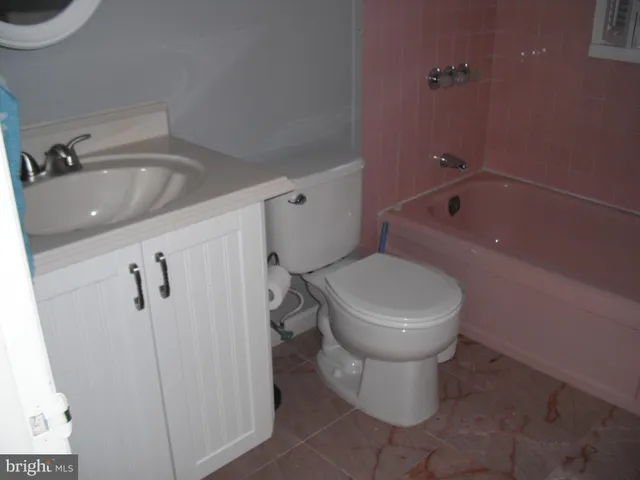 a hallway with a dresser and a window