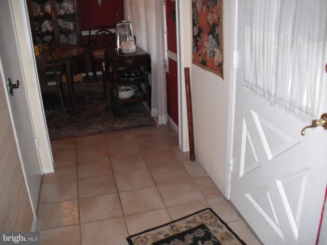 a living room with furniture a window and a lamp
