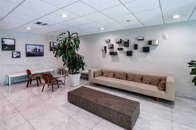 a living room with furniture and potted plant