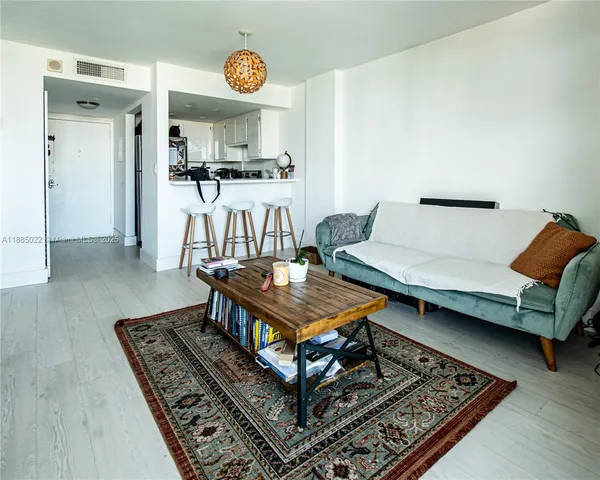 a living room with furniture and a rug