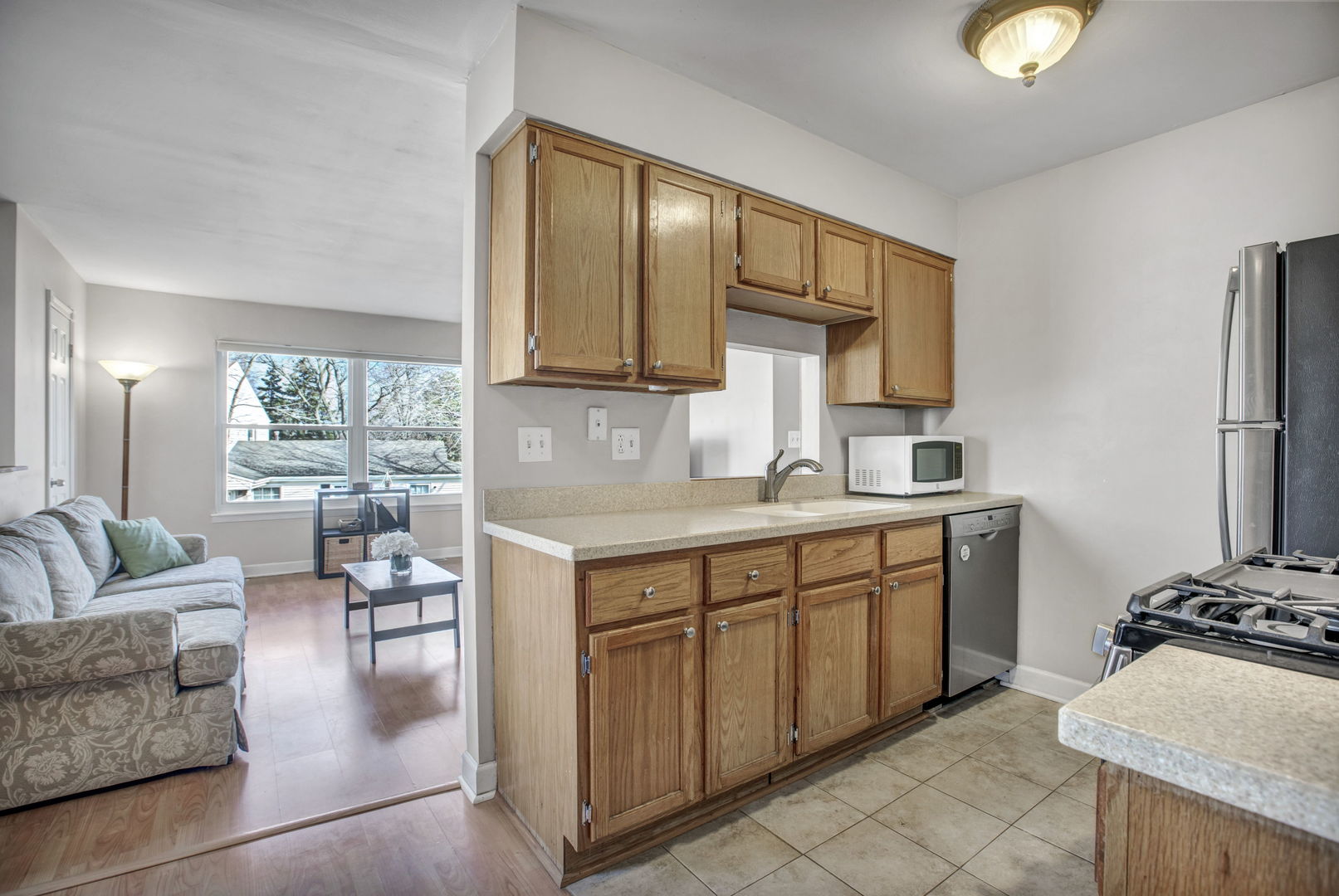 817 Pahl Road Elk Grove Village, IL 60007 - Photo 7 of 17 a kitchen with granite countertop a stove a sink and a refrigerator