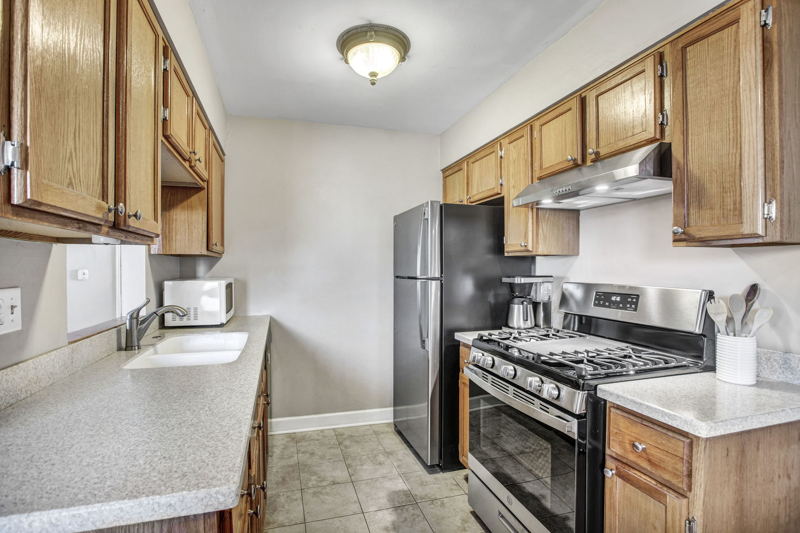 817 Pahl Road Elk Grove Village, IL 60007 - Photo 8 of 17 a kitchen with stainless steel appliances granite countertop a sink stove and refrigerator