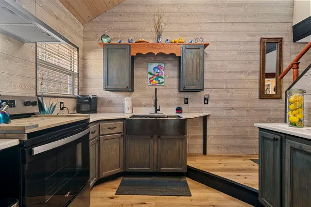 a kitchen with a sink stove and cabinets