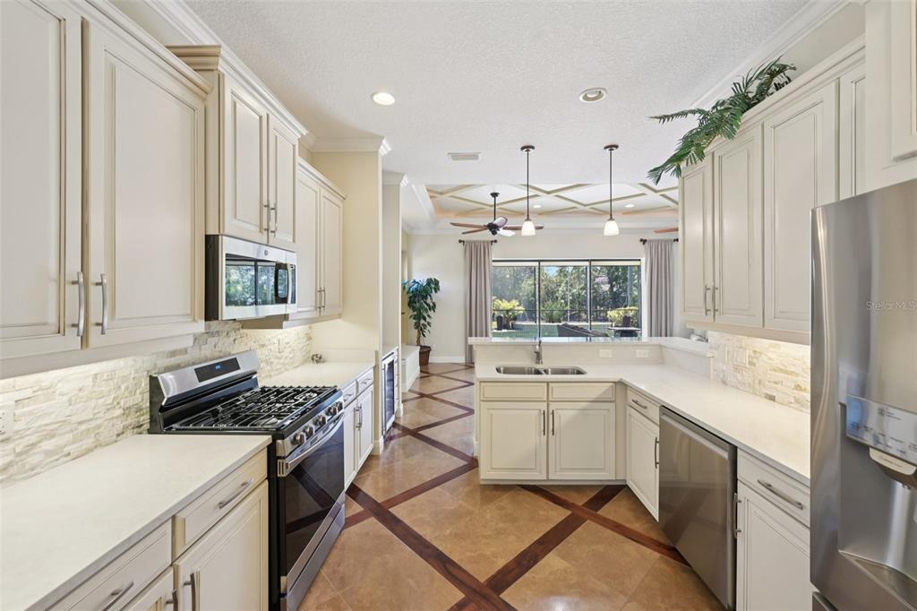 7526 Rio Bella Place Bradenton, FL 34201 - Photo 13 of 40 a kitchen with a sink stove and refrigerator