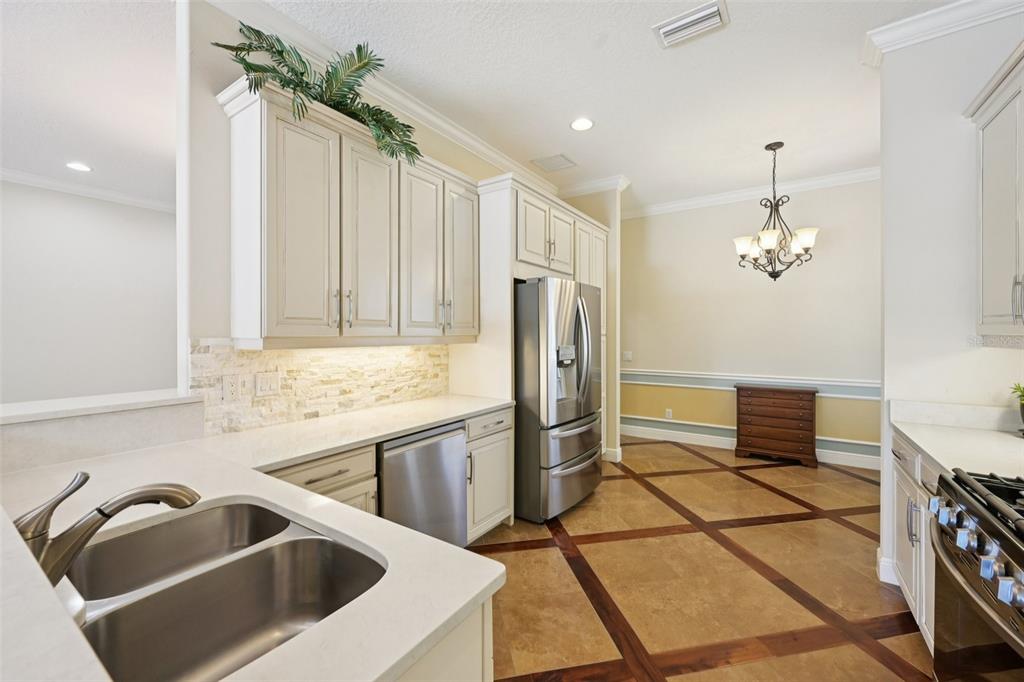 7526 Rio Bella Place Bradenton, FL 34201 - Photo 14 of 40 a kitchen with a refrigerator sink and cabinets