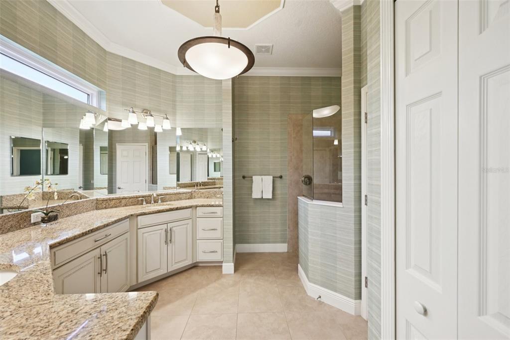 7526 Rio Bella Place Bradenton, FL 34201 - Photo 25 of 40 a spacious bathroom with a double vanity sink and a mirror