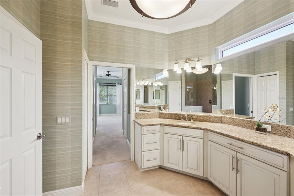 7526 Rio Bella Place Bradenton, FL 34201 - Photo 26 of 40 a spacious bathroom with a granite countertop sink a mirror and a