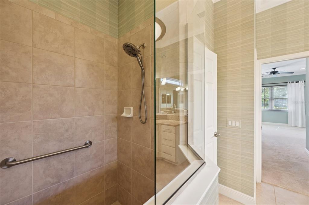 7526 Rio Bella Place Bradenton, FL 34201 - Photo 27 of 40 a bathroom with a glass shower door