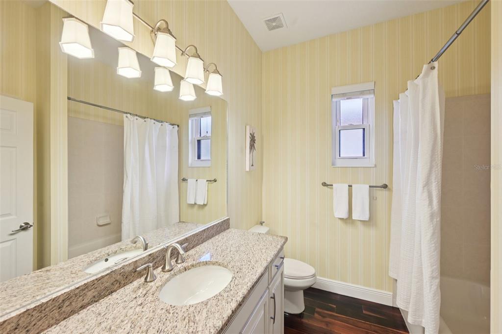 7526 Rio Bella Place Bradenton, FL 34201 - Photo 32 of 40 a bathroom with a granite countertop sink toilet and shower