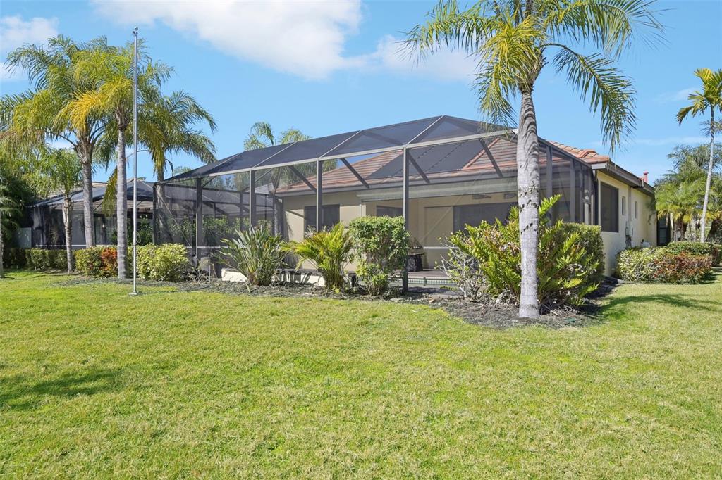 7526 Rio Bella Place Bradenton, FL 34201 - Photo 34 of 40 a view of a house with a yard and palm trees