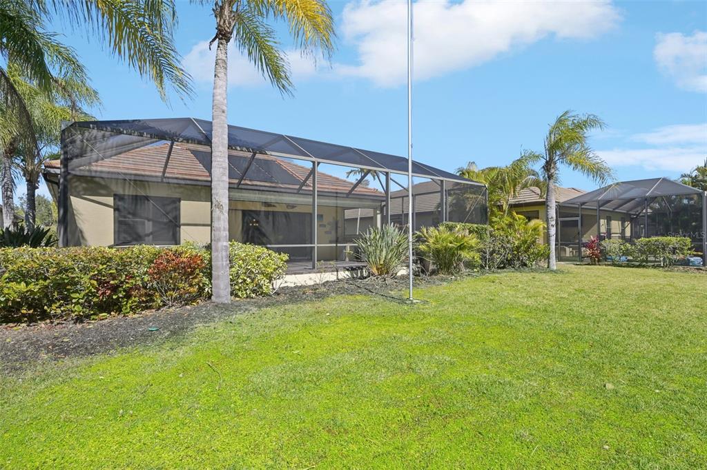 7526 Rio Bella Place Bradenton, FL 34201 - Photo 35 of 40 a view of a house with a yard and potted plants