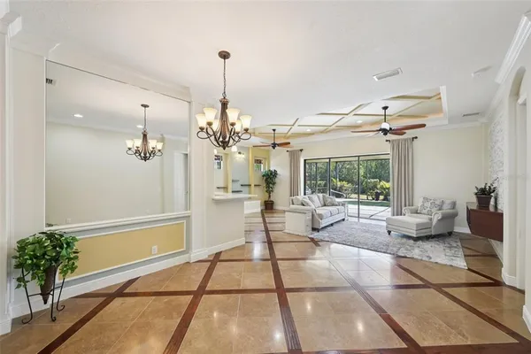 a living room with furniture and a ceiling fan