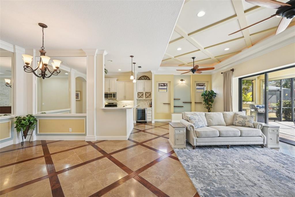 7526 Rio Bella Place Bradenton, FL 34201 - Photo 10 of 40 a living room with couches a chandelier and a dining table with wooden floor