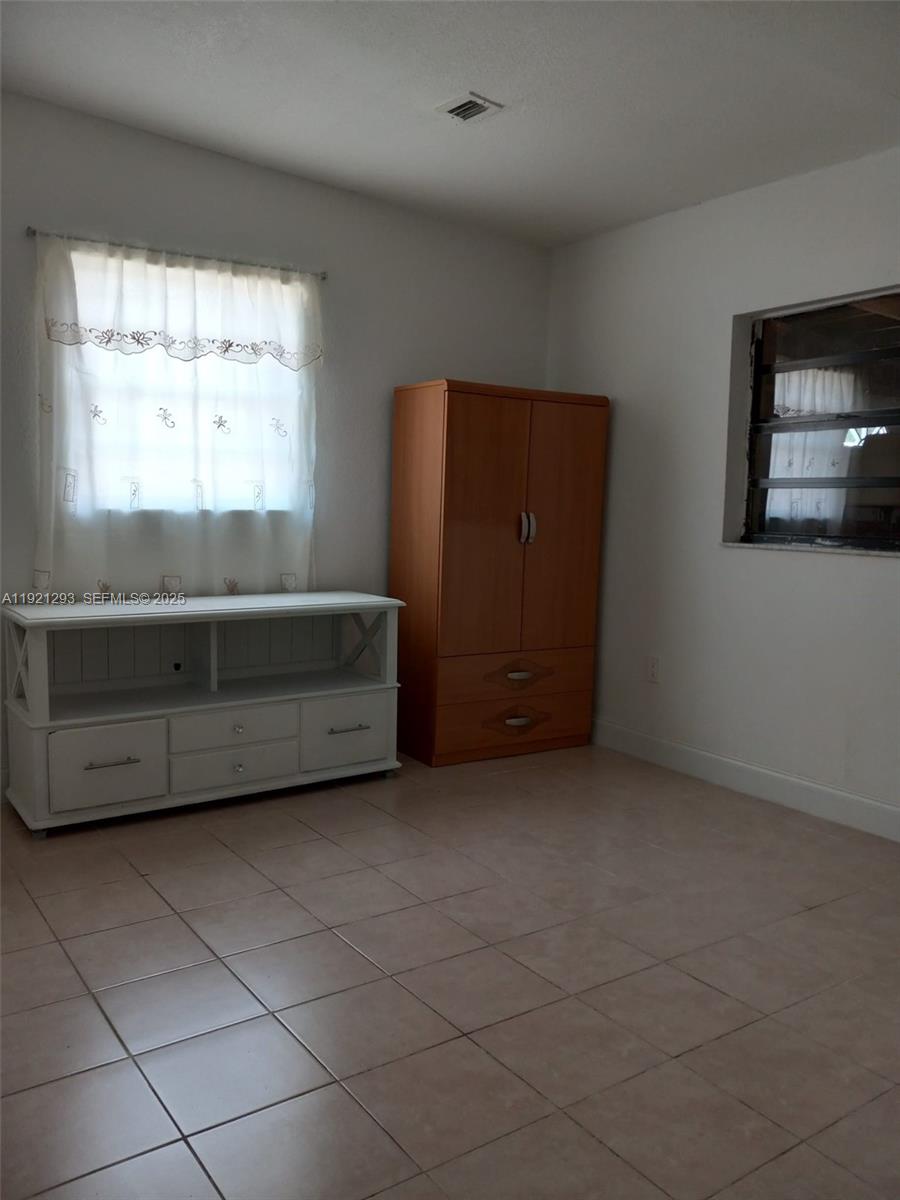 3041 Northwest 95th Terrace Miami, FL 33147 - Photo 12 of 22 a living room with a bed and a window