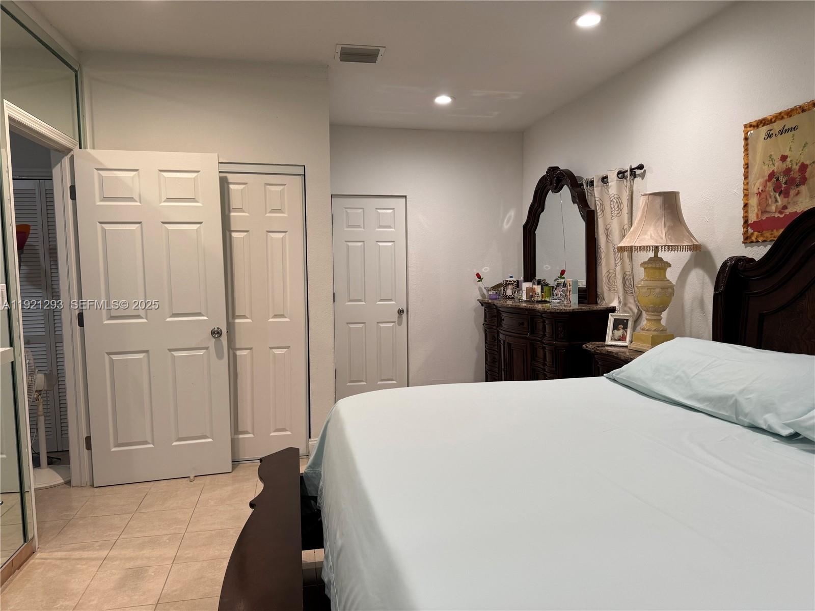 3041 Northwest 95th Terrace Miami, FL 33147 - Photo 13 of 22 a bedroom with a bed and a chandelier