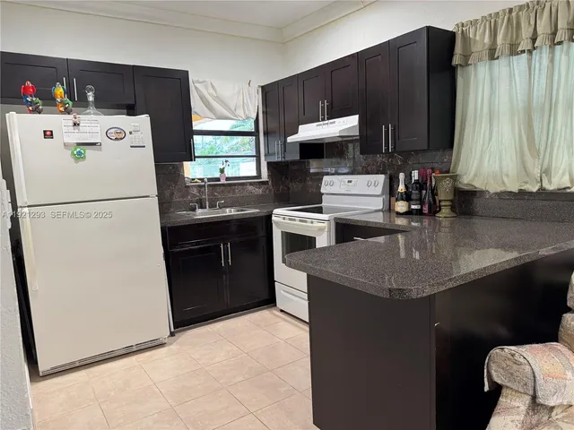 a kitchen with a sink a stove and refrigerator
