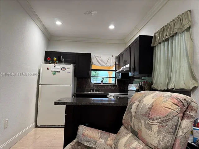 a kitchen with a refrigerator and a stove