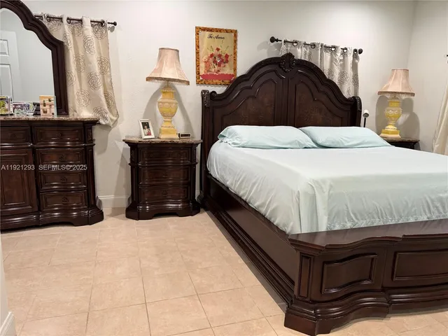 a bedroom with a bed and a dresser