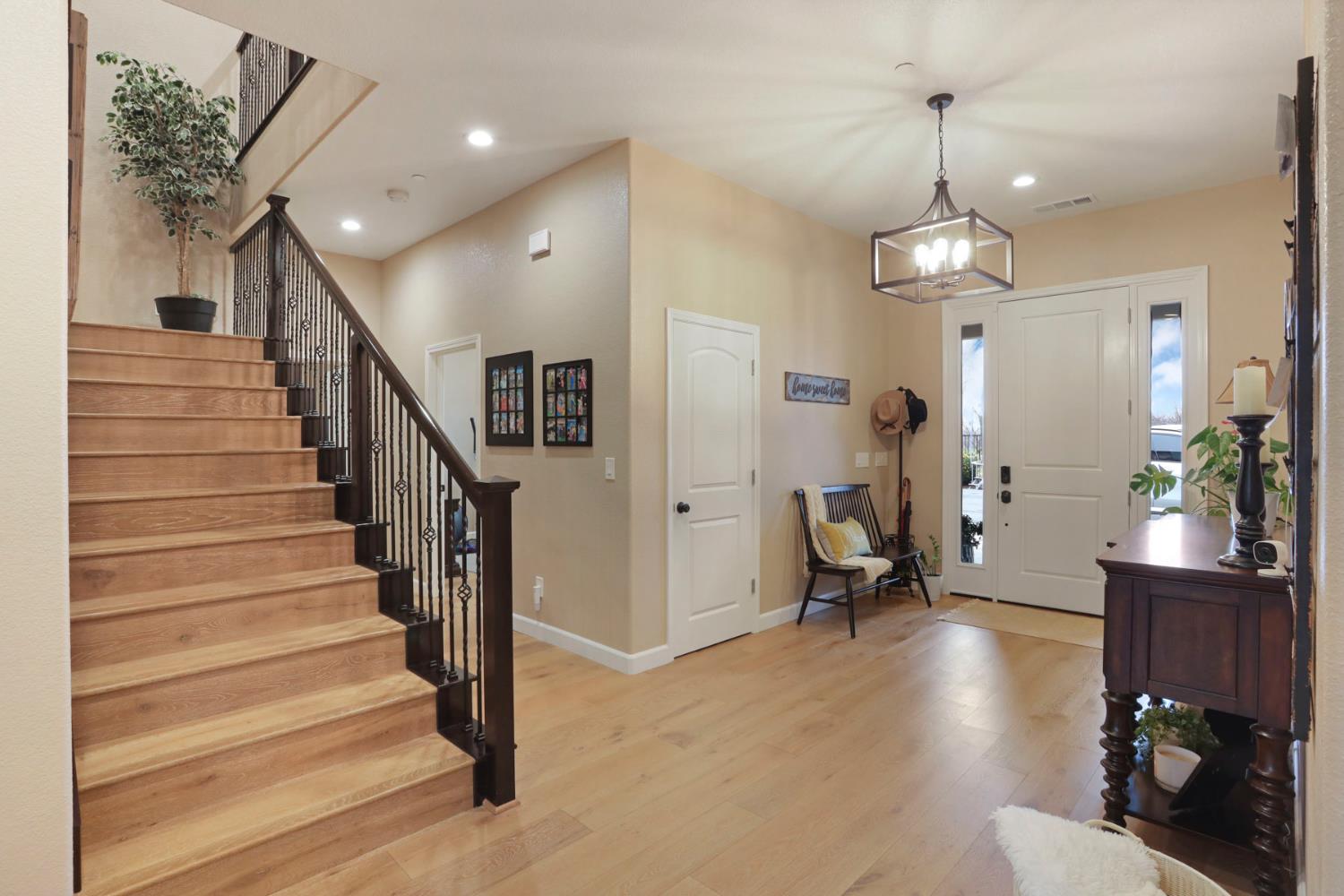23346 Frederick Road Ripon, CA 95366 - Photo 12 of 96 a view of a hallway with wooden floor and stairs